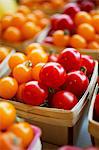 Red and yellow cherry tomatoes in wooden baskets