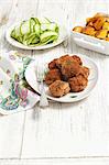 Meatballs served with a courgette salad and roast potatoes