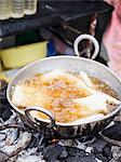 Deep-fried casava in hot oil at a local market on Zanzibar