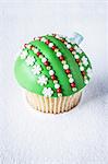 A green Christmas bauble cupcake