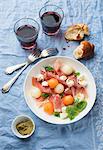 Melon with Prosciutto and mozzarella served with red wine and baguette