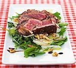 Grilled beef steak on a bed of lettuce