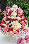 A meringue cake with berries and flowers