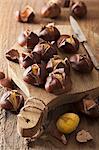 Roasted chestnuts on a chopping board