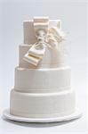 An elegant wedding cake with a white bow