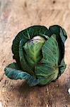 A cabbage on a wooden surface