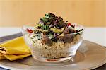 Rice salad with Portobello mushrooms, roasted peppers, dried tomatoes, kale and walnuts