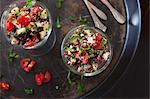 Salad with red quinoa, tomatoes, cucumber, feta cheese and mint