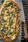Pizza with pear, blue cheese, garlic, cheese and herbs