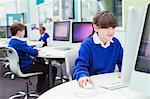 Primary school children working with computers during IT lesson