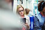 Businesswoman using digital tablet on train