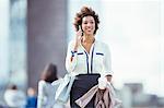 Businesswoman talking on cell phone in city