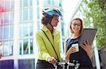 Businesswomen using digital tablet outdoors