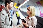 Business people talking in subway station