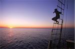 Man Watching Sunset from Rigging aboard Tree of Life