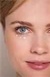 Beautiful woman applying concealer