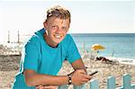 Teenager beach summer holiday fence mobile phone