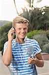 Portrait male teenager listening music MP3 player