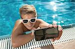 Close-up teenager boy swimming pool self-portrait