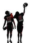 two american football players walking,rear view in silhouette shadow on white background