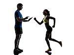 one woman exercising jogging with man coach using digital tablet in silhouette on white background