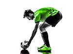 one soccer football player young man preparing free kick in silhouette studio on white background