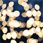 christmas  blue background with golden bokeh light beams