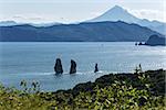 Three Brothers Rocks in Avacha Bay and Viluchinsky volcano. Russia, Far East, Kamchatka Peninsula.