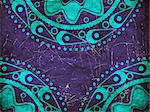 Abstract blue ornament on grunge violet background.