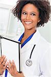 A black African American female medical doctor using a tablet computer in a hospital