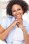 A beautiful black mixed race African American girl or young woman looking happy and smiling