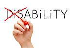 Hand turning the word Disability into Ability with red marker isolated on white.