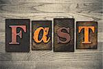 The word "FAST" written in wooden letterpress type.