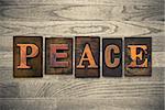 The word "PEACE" written in wooden letterpress type.