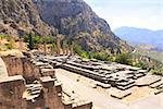 Ancient column and ruins of Temple of Apollo in the archaeological site of Delphi, Greece