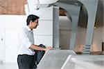 Asian Indian businessman standing by airport check in counter