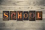 The word "SCHOOL" written in wooden letterpress type.