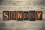 The word "SUNDAY" written in wooden letterpress type.