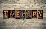 The word "THERAPY" written in vintage wooden letterpress type.