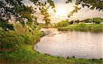 Beautiful sunset over lake near a village