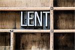 The word "LENT" written in vintage metal letterpress type sitting in a wooden drawer.