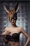 very sexy woman posing in glamour easter portrait with mysterious bunny mask and lace fashion lingerie