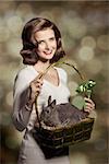 Beautiful, natural brunette woman with nice short hairstyle, and easter basket with little rabbit.