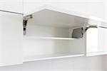 opened white kitchen cabinet with empty shelf