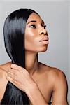 Profile of an young black beauty with long straight and shiny hair