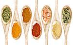 healthy seasoning and spices - a collection of isolated wooded spoons