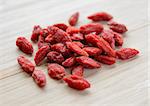 Heap of Dry Goji Berries on the Wooden Table. Healthy Diet