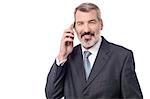 Smiling businessman talking on cell phone over white