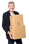 Senior corporate man holding stack of boxes