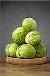 A heap of fresh brussels sprouts on wooden table